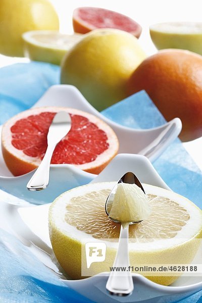 Slice of grapefruit with special spoon and knife