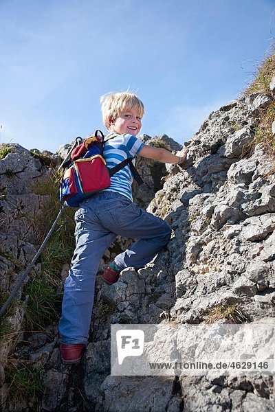 Boy (4-5 Years) climbing mountain  smiling  portrait