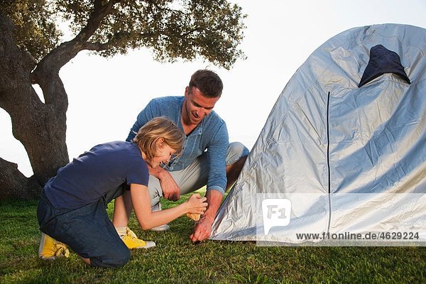Kroatien  Zadar  Vater und Tochter beim Aufstellen des Zeltes