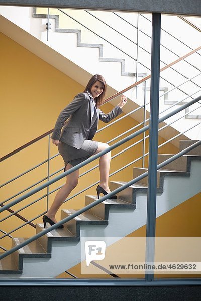 Business woman climbing stairscase