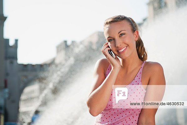 Young woman on the phone  smiling