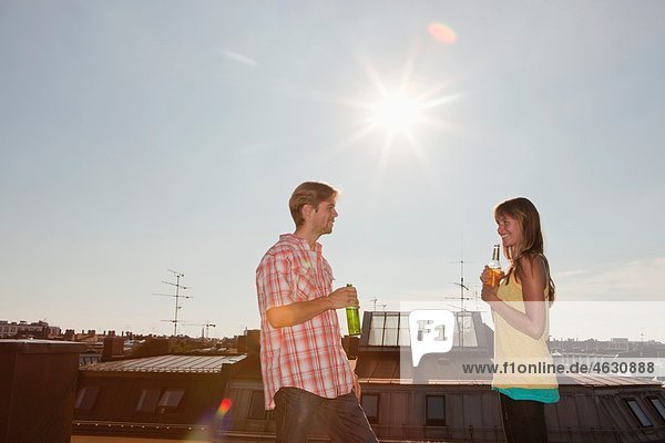 Man and woman talking on rooftop