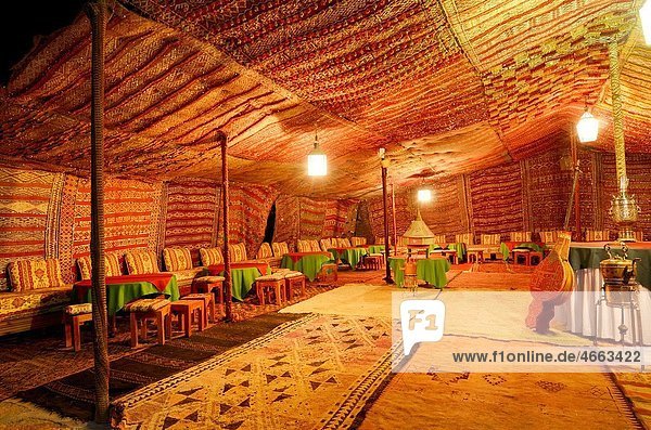 Large empty carpeted Berber tent at night in Tinerhir Morocco