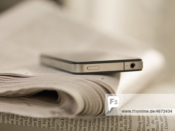 Smartphone and newspaper