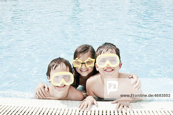 Children in pool wearing swimming goggle