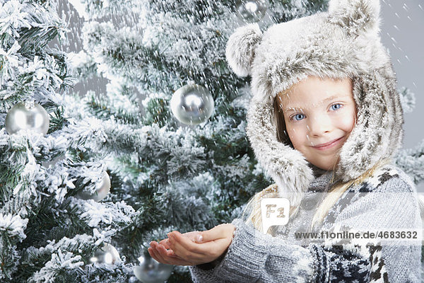 Girl under the snow  by christmas trees