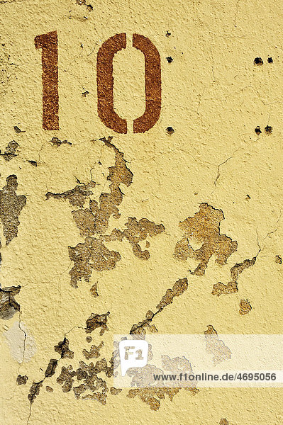 The number ten on crumbling plaster