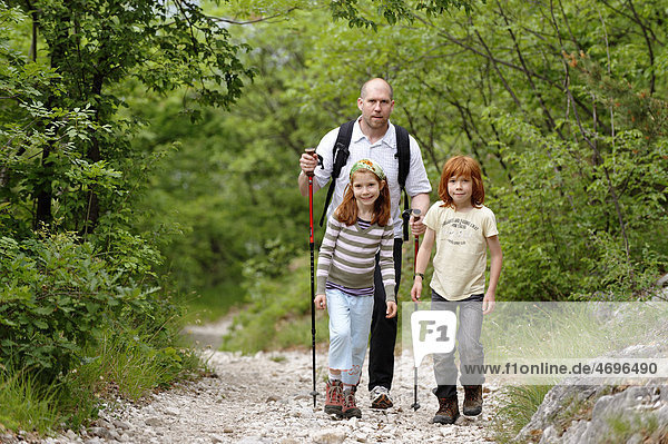 Father and children hiking on the Albrecht Duerer Weg near Laag  Oltradige  Bolzano Lowlands  South Tyrol  Italy  Europe