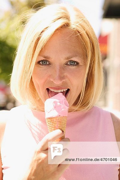 Woman eating an ice cream cone.