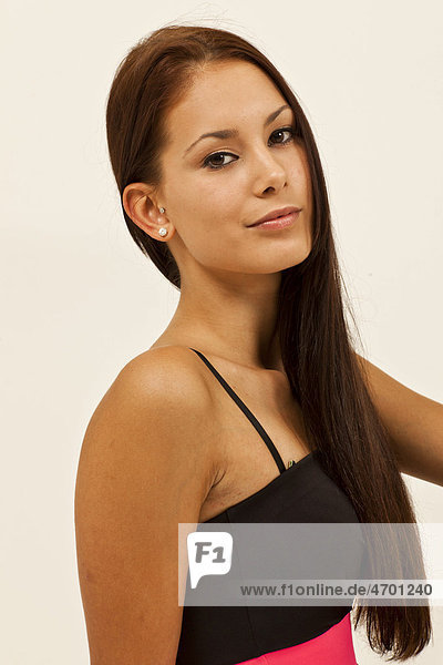 Portrait of a young woman with long brown hair