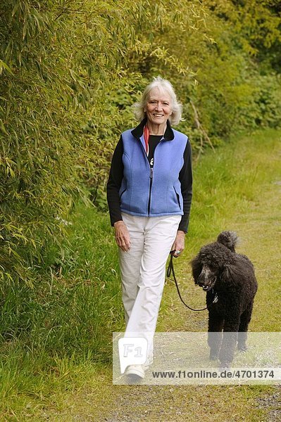 A woman walking her dog.