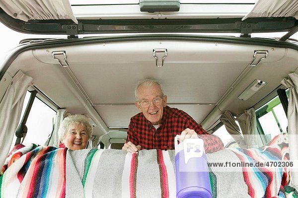 Senior couple in the back of their van