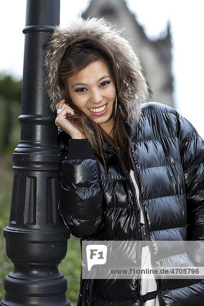 Smiling young woman posing in a winter jacket