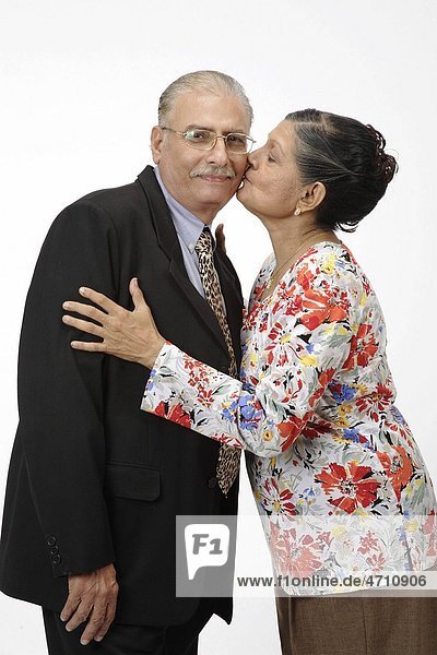 Old couple old woman kissing old man cheek MR 703B and 703A
