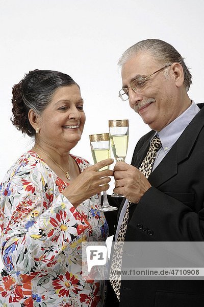 Old couple old man and woman holding champagne glasses tossing for cheers MR 703B 703A