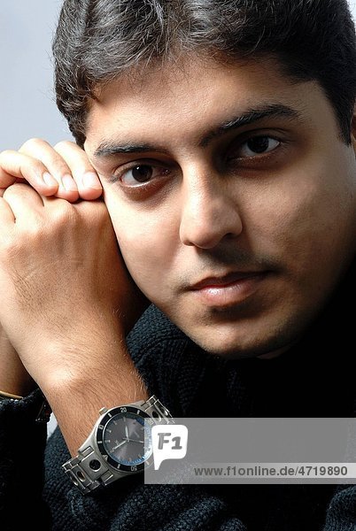 South Asian Indian man thinking about future looking at camera MR628