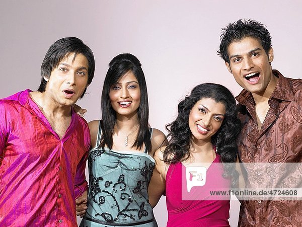 South Asian Indian men and women standing together in party MR