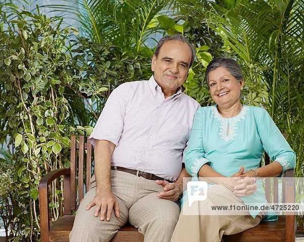 Old couple sitting on wooden bench MR702T 702S