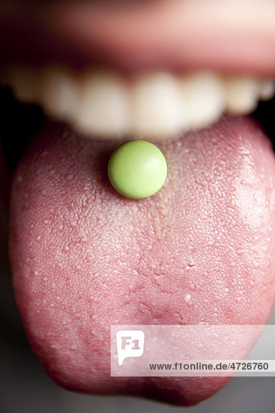 Tablet  pill on a tongue  mouth