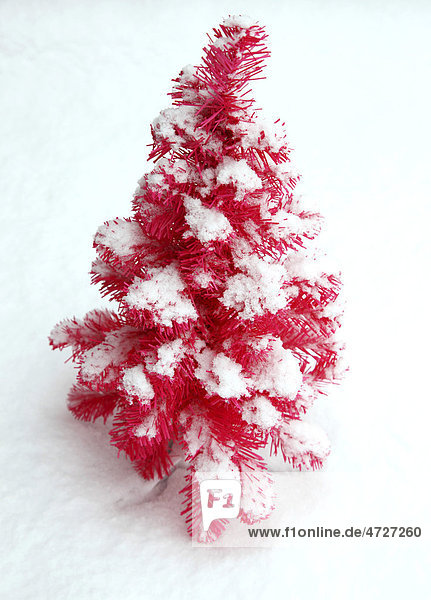 Pink plastic Christmas tree covered with snow  Christmas decoration