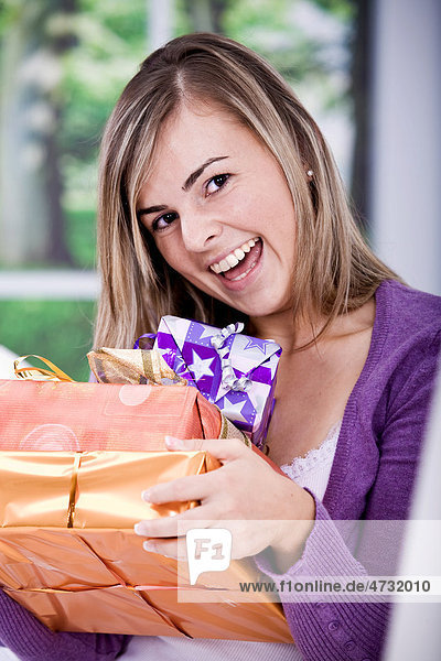 Young woman holding presents