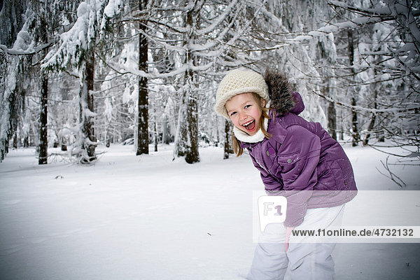 Girl playing in a winter forest