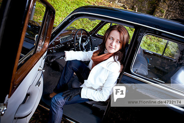 Young woman in a vintage MB vehicle