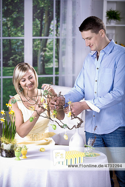 Young couple decorating for Easter