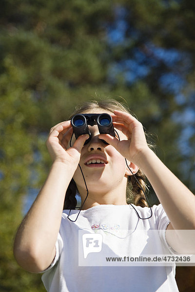 Girl looking through binoculars