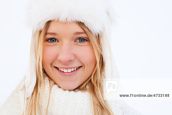 Portrait of teenage girl in white winter clothing