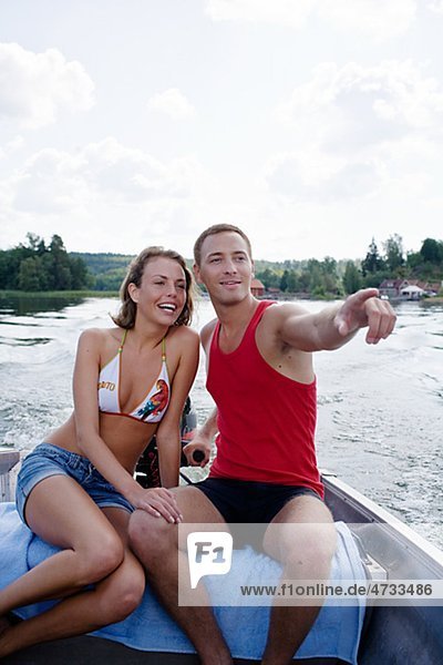 Young couple in motorboat on lake
