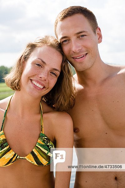 Young couple in swimsuits smiling