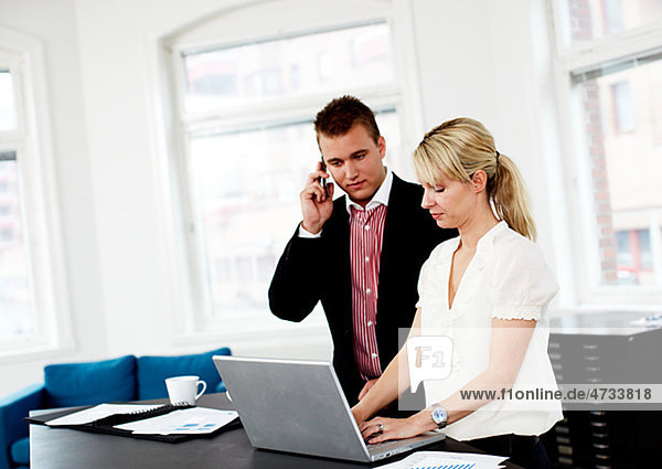 Businessman and woman working in office