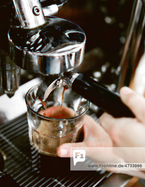 Close-up of person making espresso