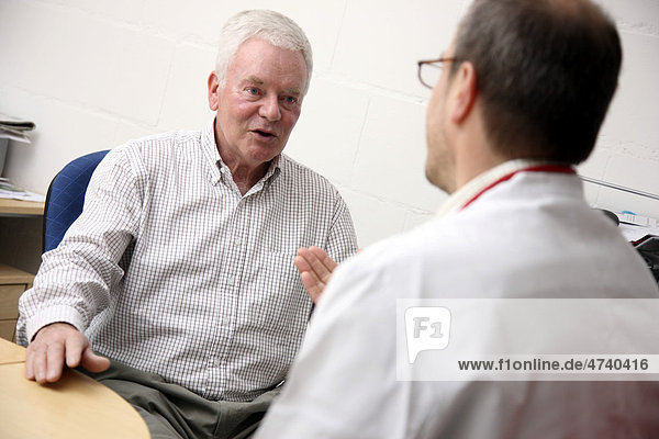 Man  senior  about 70 years old  having a conversation with his doctor  general practitioner