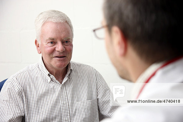 Man  senior  about 70 years old  having a conversation with his doctor  general practitioner