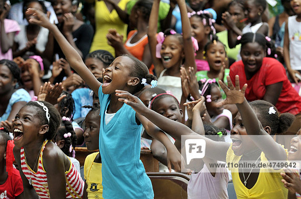 Cheering children during a theatre play at school  Petit Goave  Haiti  Caribbean  Central America