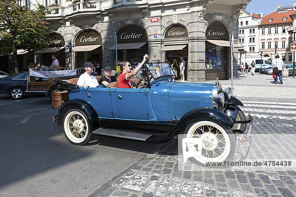 Tourists being driven around the city in a vintage car  Prague  Czech Republic  Europe