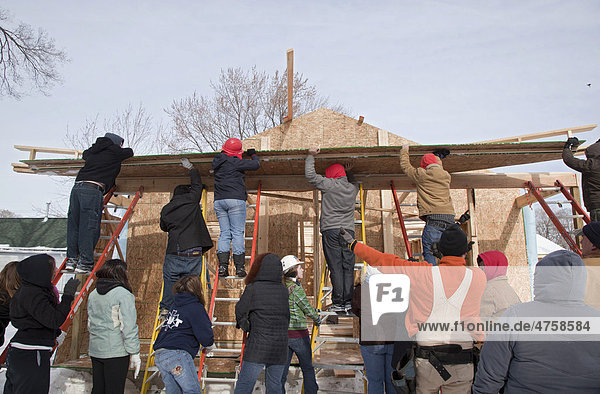 Students from Macomb Community College volunteer to help build a Habitat for Humanity house on the Martin Luther King holiday  Warren  Michigan  USA