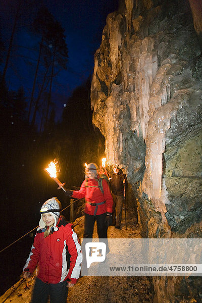Hiking with torches in the Partnachklamm gorge near Garmisch-Partenkirchen  Upper Bavaria  Bavaria  Germany  Europe