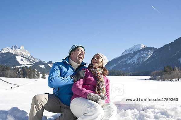 Happy couple in winter landscape  Tannheimer Tal  Tyrol  Austria