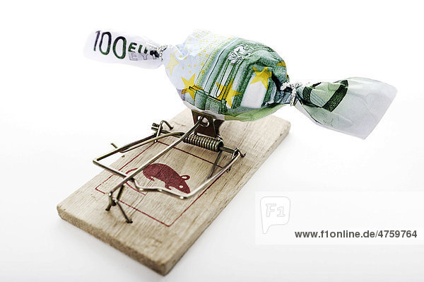 Bonbon in Geldschein eingewickelt auf Mausefalle  Symbolbild Schuldenfalle