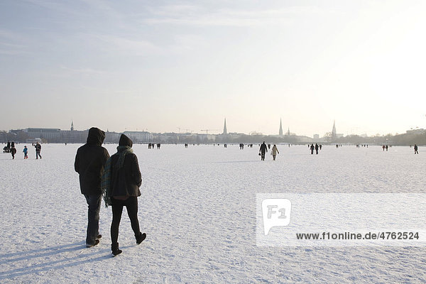 Walkers on the frozen Aussenalster or Outer Alster Lake  Hamburg  Germany  Europe