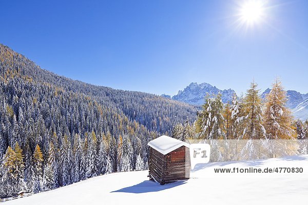 Haystack in snowy mountain landscape Sexten Alto Adige Italy