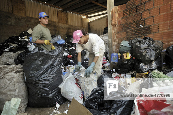 Trennen von Wertstoffen in Altmüll in einer Recycling Fabrik  Sozialprojekt Reintegar Reciclando für Ex-Häftlinge  Ceilandia  Satellitenstadt von Brasilia  Distrito Federal  Brasilien  Südamerika