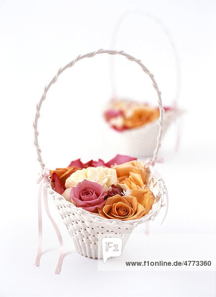 Rose petals in a white basket for a wedding