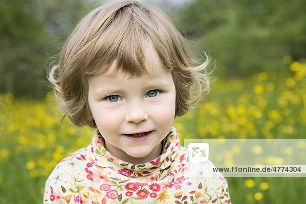 Kleines Mädchen in einer Blumenwiese  Porträt