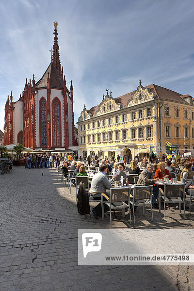Tourists sitting at a sidewalk cafe in front of the Falkenhaus building and Our Lady's Chapel  Marktplatz square  Wuerzburg  Bavaria  Germany  Europe
