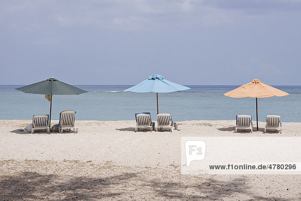 Sunloungers and beach umbrellas on the public beach of Flic en Flac  Mauritius  Africa