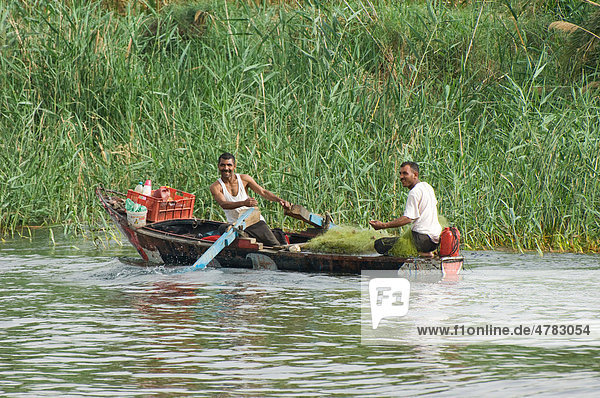 Two fishermen with nets in a small row boat  River Nile  Egypt  Africa